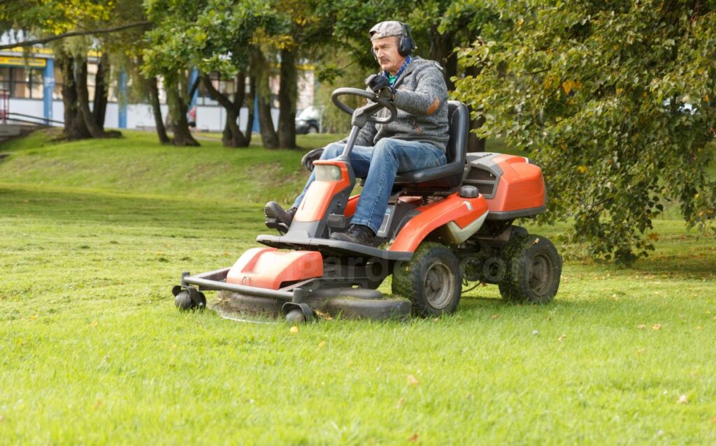 lawn mower tractor working in the town park